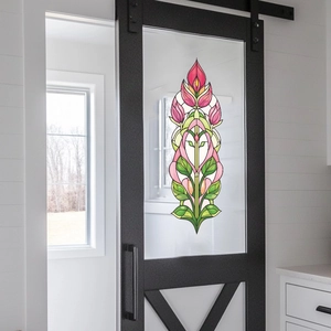 Art Deco tulip floral glass window sticker for home decor on a black barn door