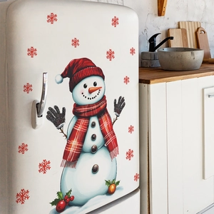 Magnets de frigo bonhomme de Noël avec flocons rouges sur réfrigérateur blanc