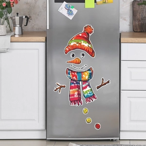 Close-up of a festive snowman magnet set with colorful scarf on a silver refrigerator
