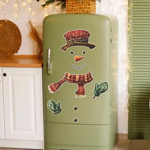 Detailed view of snowman fridge stickers with red hat and scarf on a green refrigerator