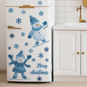 Detailed view of Christmas snowman fridge stickers on a white kitchen appliance