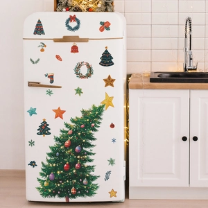 Detailed view of Christmas tree and star wall stickers on a white kitchen fridge