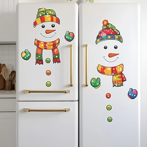 Close-up of colorful cartoon snowman decals on a white refrigerator for festive home decor