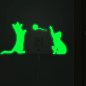 Luminous cat silhouette wall stickers glowing in bright neon green for home light switches