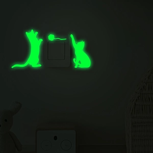 Glow-in-the-dark cat silhouettes and yarn ball wall sticker on light switch in the dark
