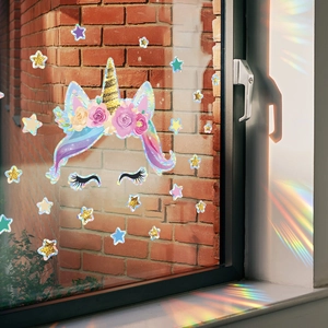 Rainbow unicorn glass sticker with glitter stars reflecting colorful light on window