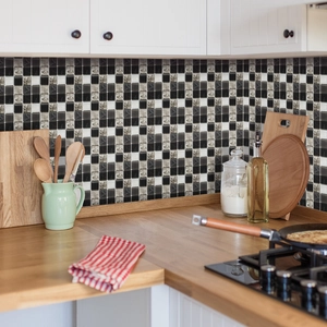 Close-up of modern self-adhesive mosaic wall tiles with grey checkerboard pattern in kitchen