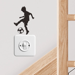 Creative black silhouette sticker of a boy playing soccer for wall or light switch decor