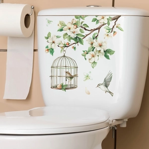 Floral bird and cage wall decals on a white ceramic toilet for home decoration