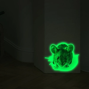 Macro detail of 3D mouse wall sticker showing green luminous glow in dark corner