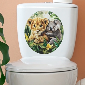Detail of round lion and koala jungle decal applied on a white ceramic toilet tank
