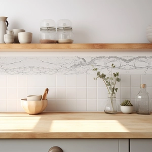 Close-up of white marble self-adhesive wall trim sticker on tiled kitchen wall