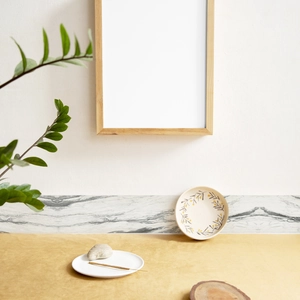 Modern light wood photo frame with marble wall border sticker in a minimalist Nordic interior