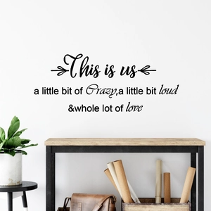 Minimalist black wall decal with This is us quote on white wall in office interior