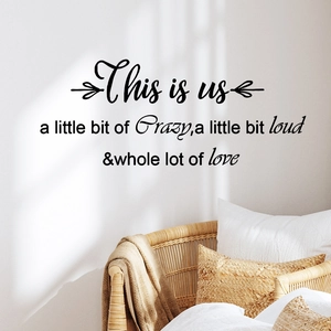Minimalist family wall decal with quote and cursive font on light grey living room wall