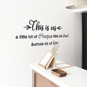 Modern self-adhesive wall decal with quote This Is Us in elegant matte black finish
