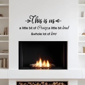 Close-up of artistic wall sticker featuring This is us family quote in modern black typography