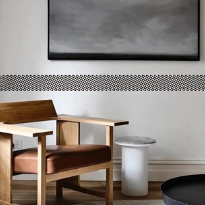 Modern black and white geometric triangle wall border stickers in a minimalist living room