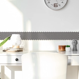 Modern black and white geometric triangle pattern wall border sticker in a bright home office