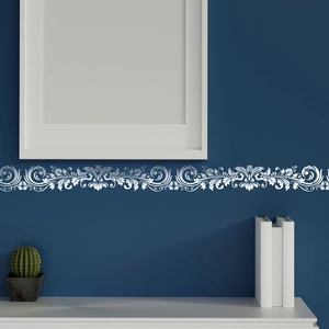 Close-up of elegant white floral wall sticker border on deep blue background