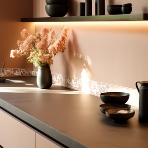 Detail showing white floral relief self-adhesive wall border in a modern kitchen setting