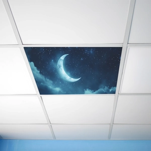Fluorescent light cover featuring a crescent moon and starry night sky in an office ceiling