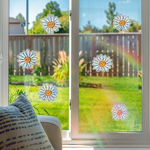 Rainbow daisy window stickers with prism effect creating colorful patterns in sunlight