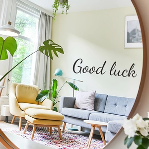 Artistic black Good Luck lettering wall sticker reflected in a round mirror for home decor