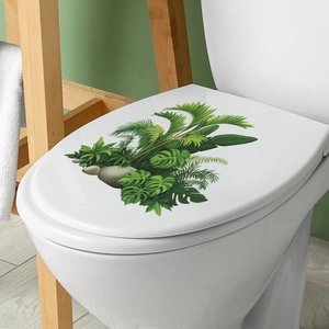 Realistic tropical monstera leaf and pebble stickers applied on a white toilet lid