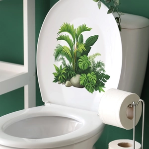 Tropical monstera leaf and stone stickers on a white toilet lid for bathroom decor