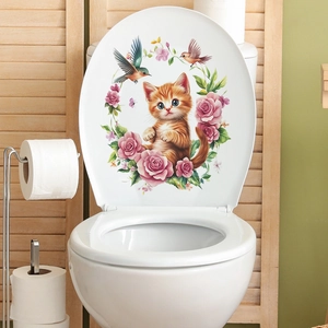 Détail de stickers chat et roses appliqués sur la surface d'un abattant de WC blanc