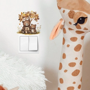 Cartoon bear family wall decal applied above a white light switch in a cozy nursery room