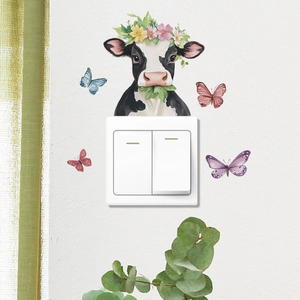 Cow head wall sticker with floral crown and colorful butterflies for switch decor