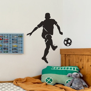 Black silhouette wall sticker of a football player shooting on white bedroom wall