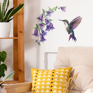 Vibrant purple morning glory and hummingbird wall decals in a modern living room scene