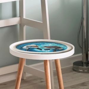 Round wooden stool featuring a 3D dolphin ocean swimming pattern on a blue seat surface