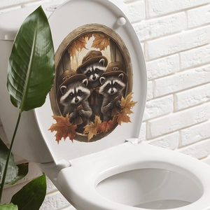 Detailed view of autumn raccoon and maple leaf stickers on a white toilet lid