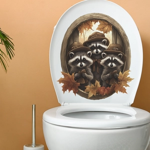 Detail of toilet lid sticker featuring cartoon raccoons, pumpkins, and autumn maple leaves