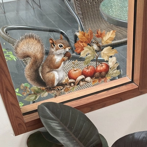 Fall themed static window clings featuring squirrels, apples and leaves on a glass window