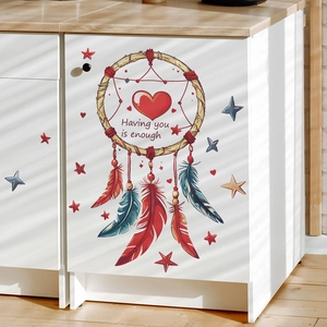 Colorful dreamcatcher wall sticker with feathers and stars on a white cabinet surface
