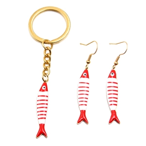 Detail of red and white striped enamel fish pendant set with gold keychain and hook earrings