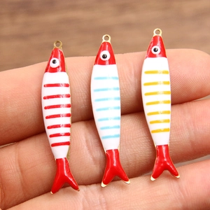 Three colorful enamel fish charms in red, blue, and yellow stripes for DIY jewelry making