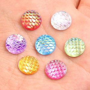 Colorful round gradient mermaid scale resin charms for DIY jewelry making held in palm