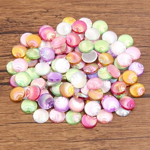 Detailed view of iridescent shell-shaped acrylic beads with gradient luster for DIY crafts