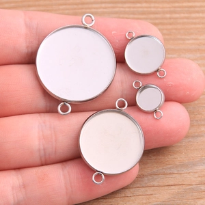 Set of four stainless steel round pendant trays with double loops for DIY jewelry