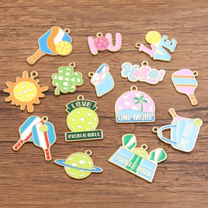 Detailed macro view of colorful pickleball enamel charms on dark wood background