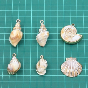 Golden acrylic sea shell charms for DIY jewelry making including starfish and conch shapes