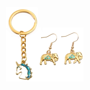 Gold unicorn keychain and elephant earrings set with teal enamel in stainless steel
