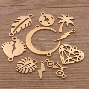 Set of 10 gold stainless steel charms including moon, heart, and tree for DIY jewelry making