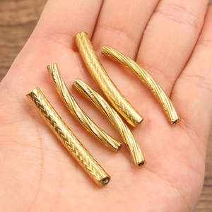 Five gold-plated stainless steel curved tube beads with spiral and herringbone embossing